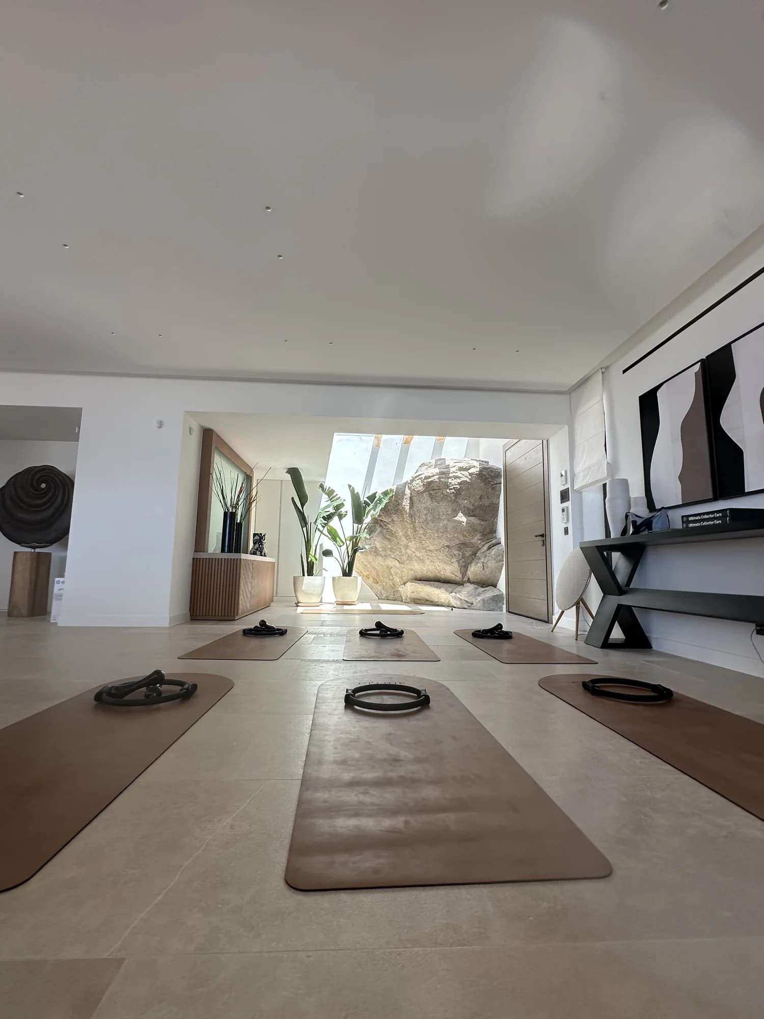 Villa interior with CÉLINE's branded arch mats laid out ready for a private session