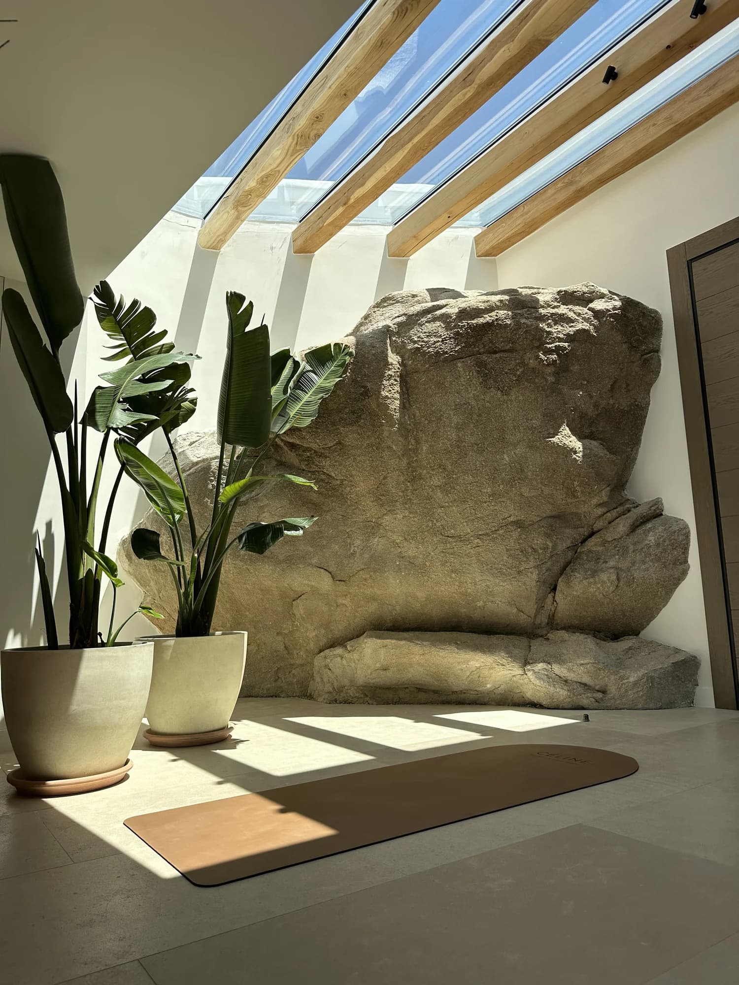 Beams of light falling through a villa skylight onto the practice space